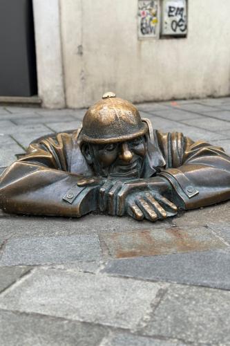 Statue of figure in manhole